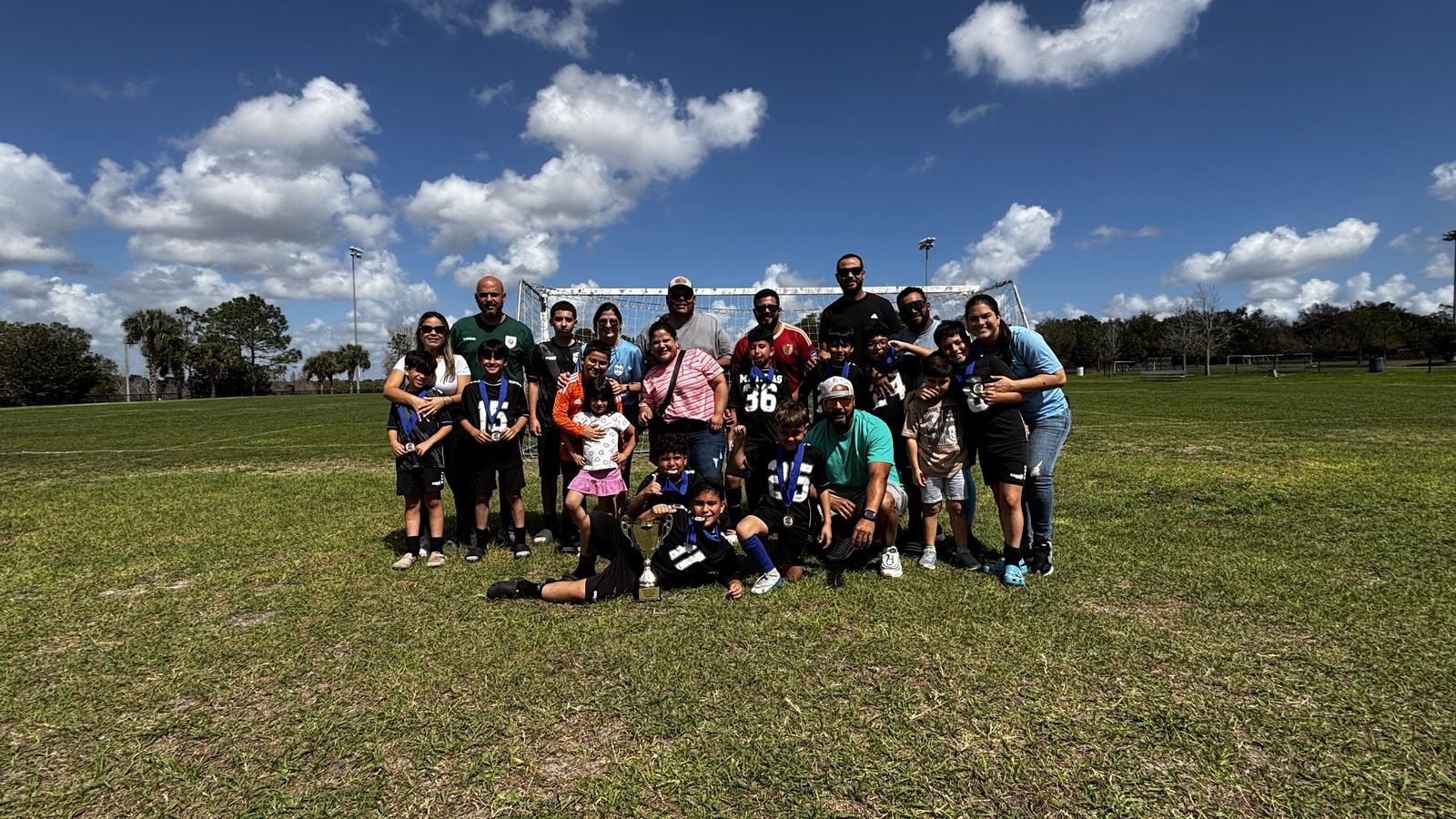 DSA players, families, and coaches together on the field