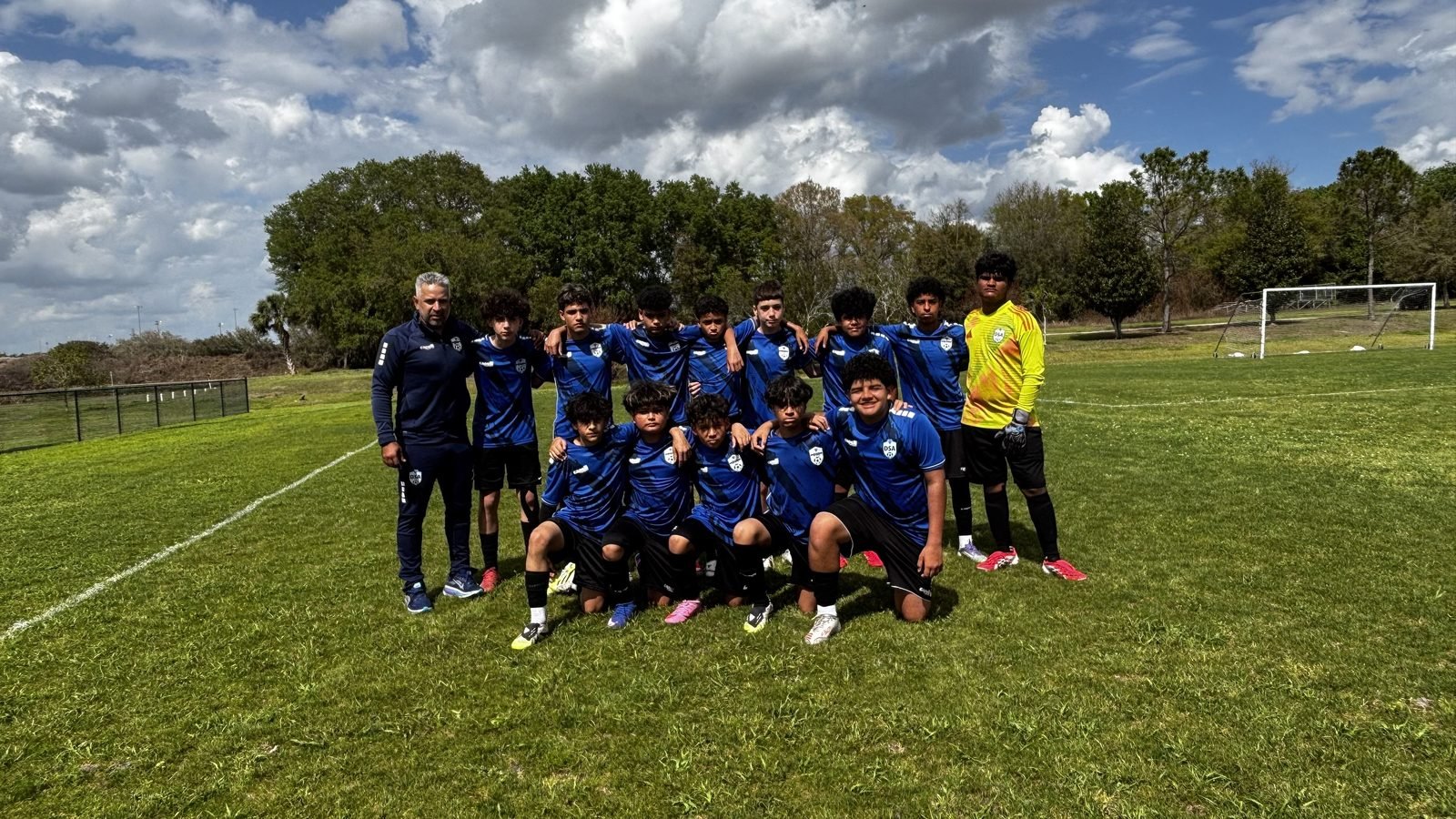 DSA competitive team and coach on the field