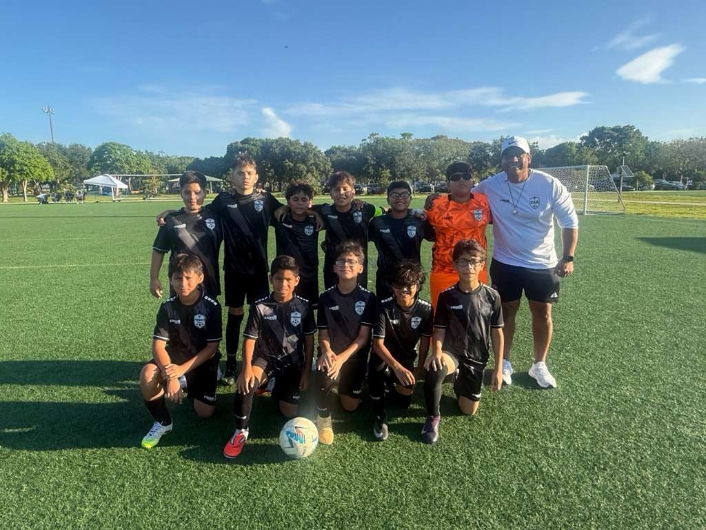 DSA youth team with a coach on the field